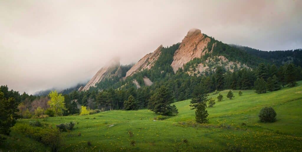 Green meadow below the Flatirons in Boulder, Colorado