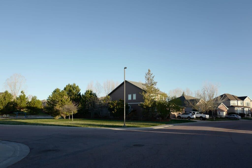 Tree-lined residential street with houses in a Denver-area neighborhood like Englewood