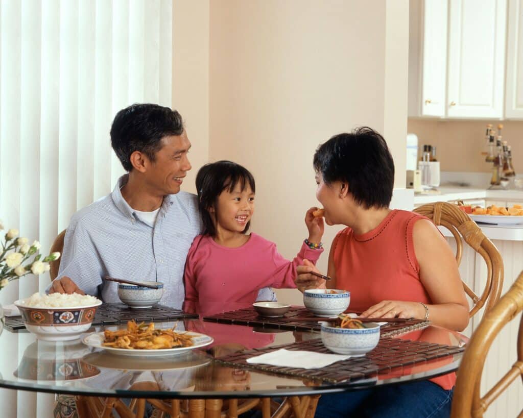 Family gathered around a table discussing an inherited house
