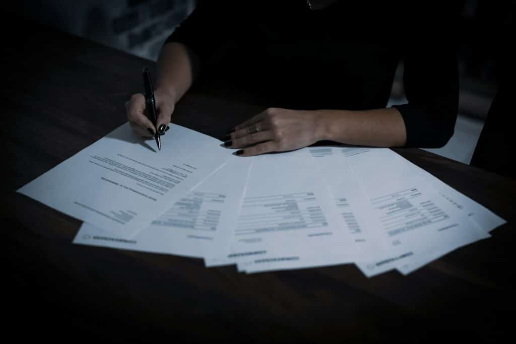 Woman reviewing paperwork for a cash offer on her home