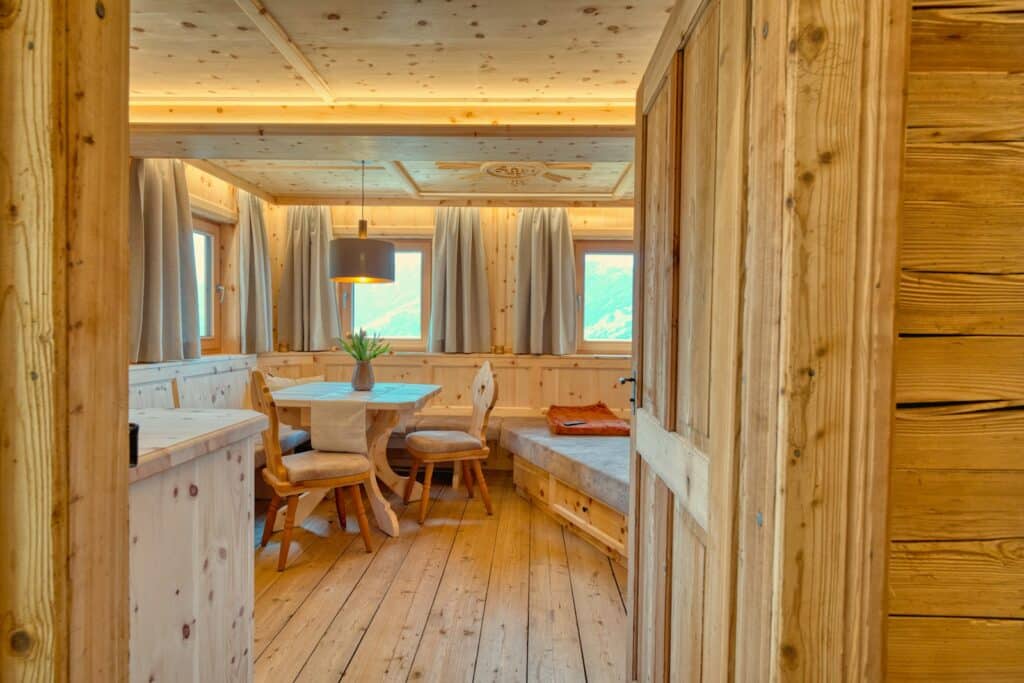 Cozy wood-paneled living and dining room in a Colorado ski town vacation rental