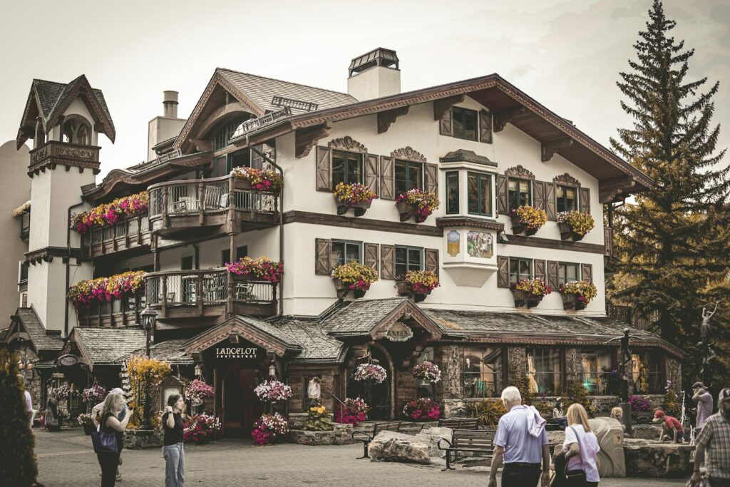 Alpine-style building with flower-filled balconies in a Colorado ski village like Vail